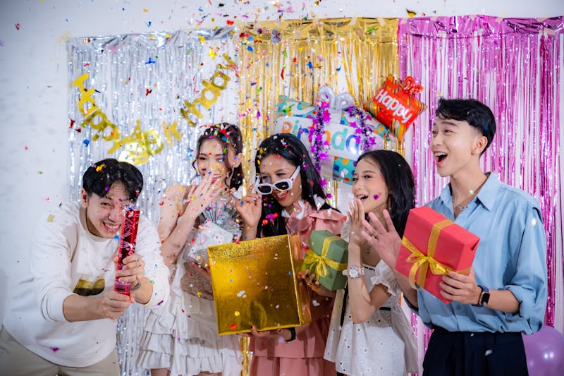Group of friends celebrating a birthday with confetti