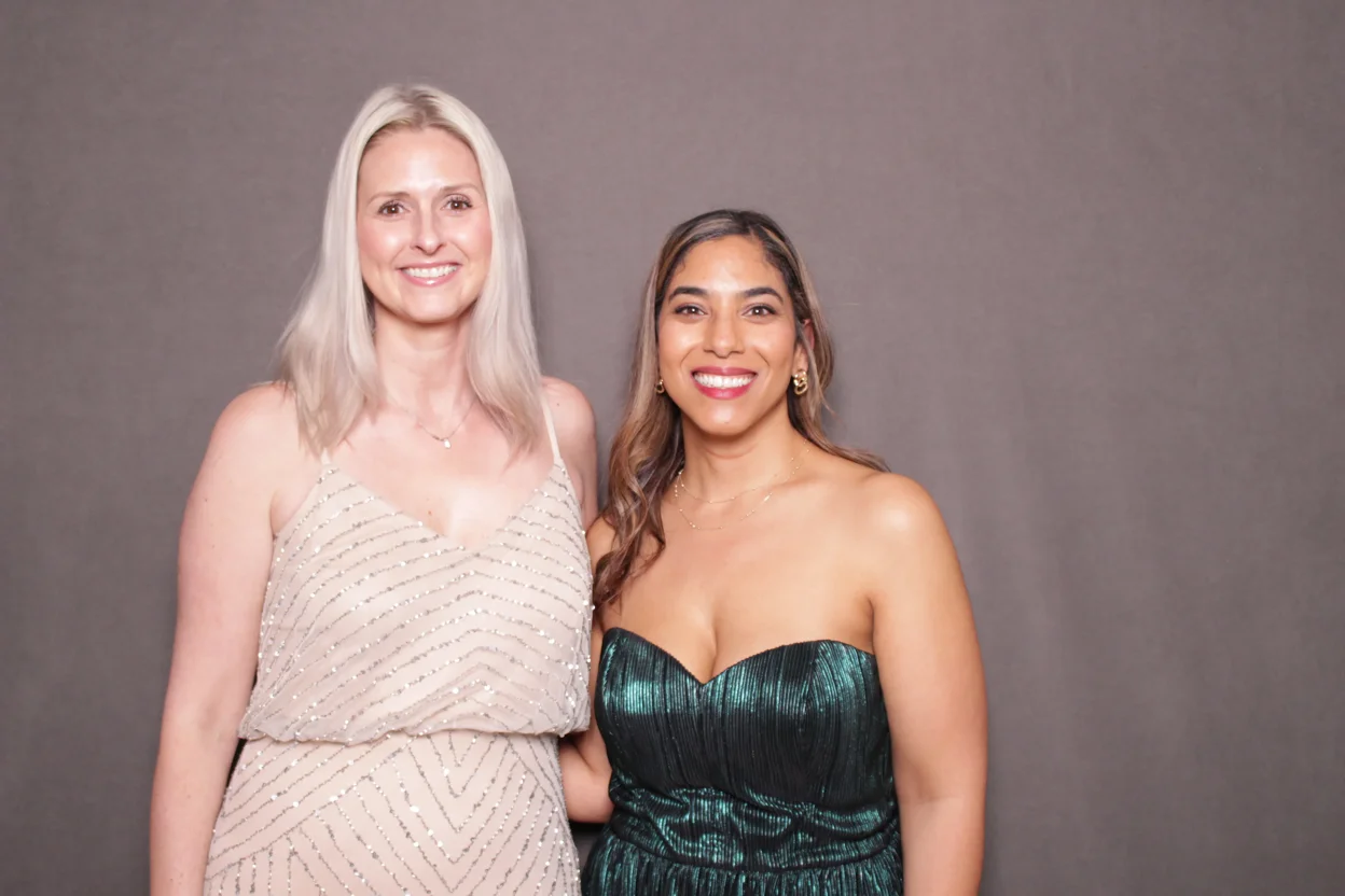 Two guests posing at the AI photo booth